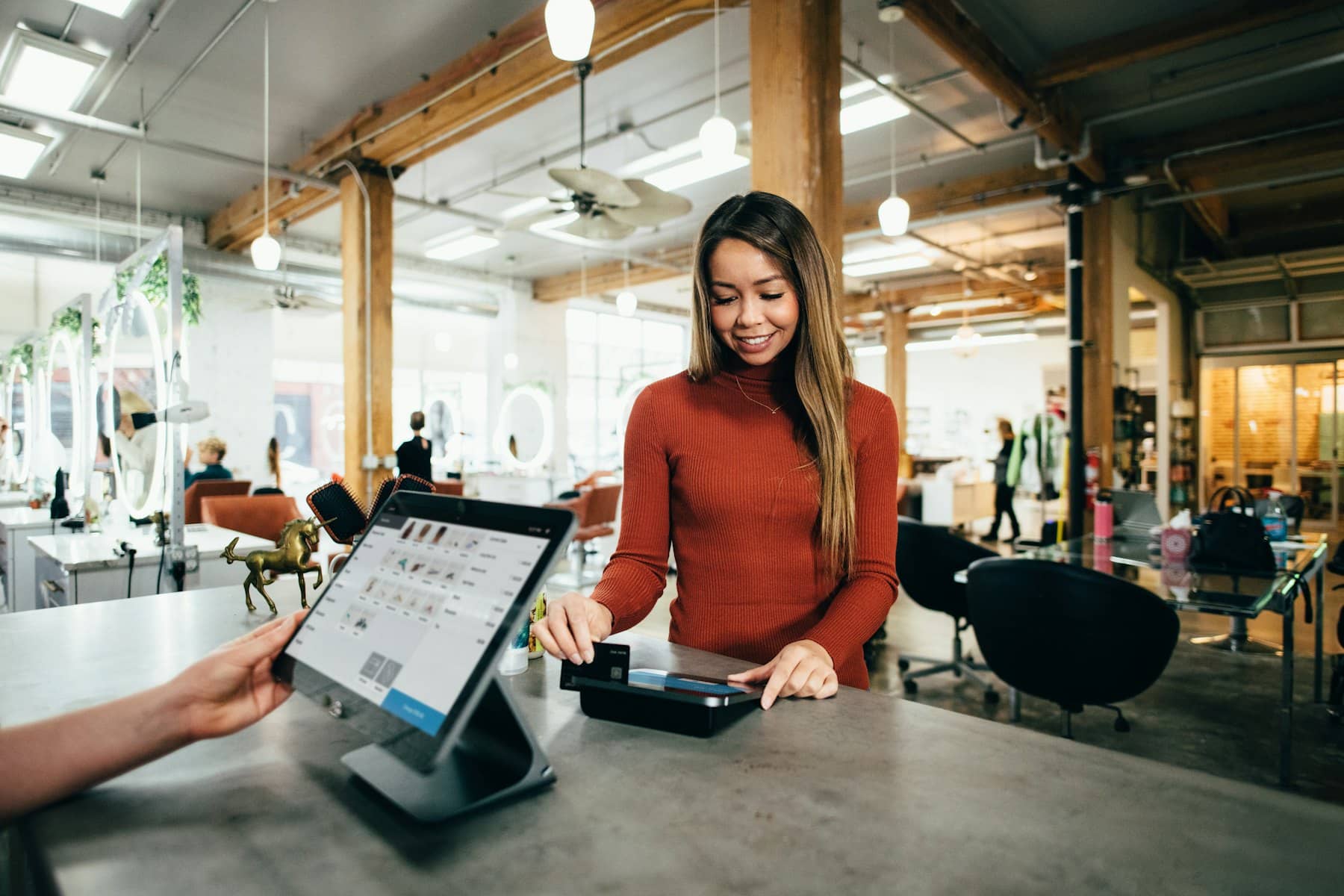 A customer paying by card at the counter