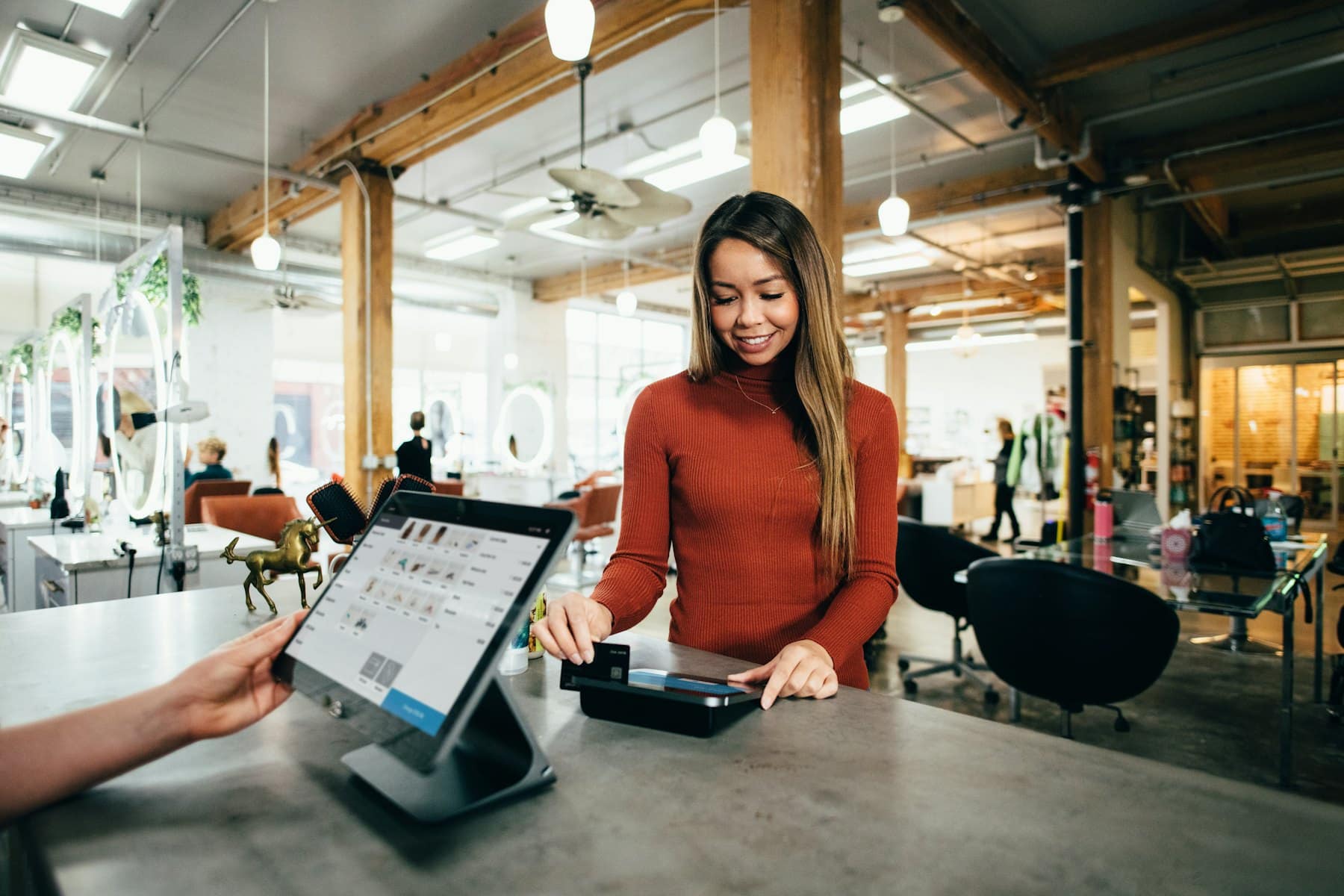 A customer paying by card at the counter